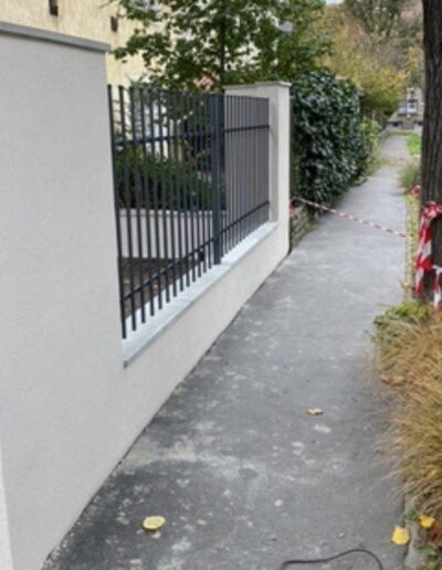 beton kerítés fedlap modern fém kerítéssel családi ház udvarán